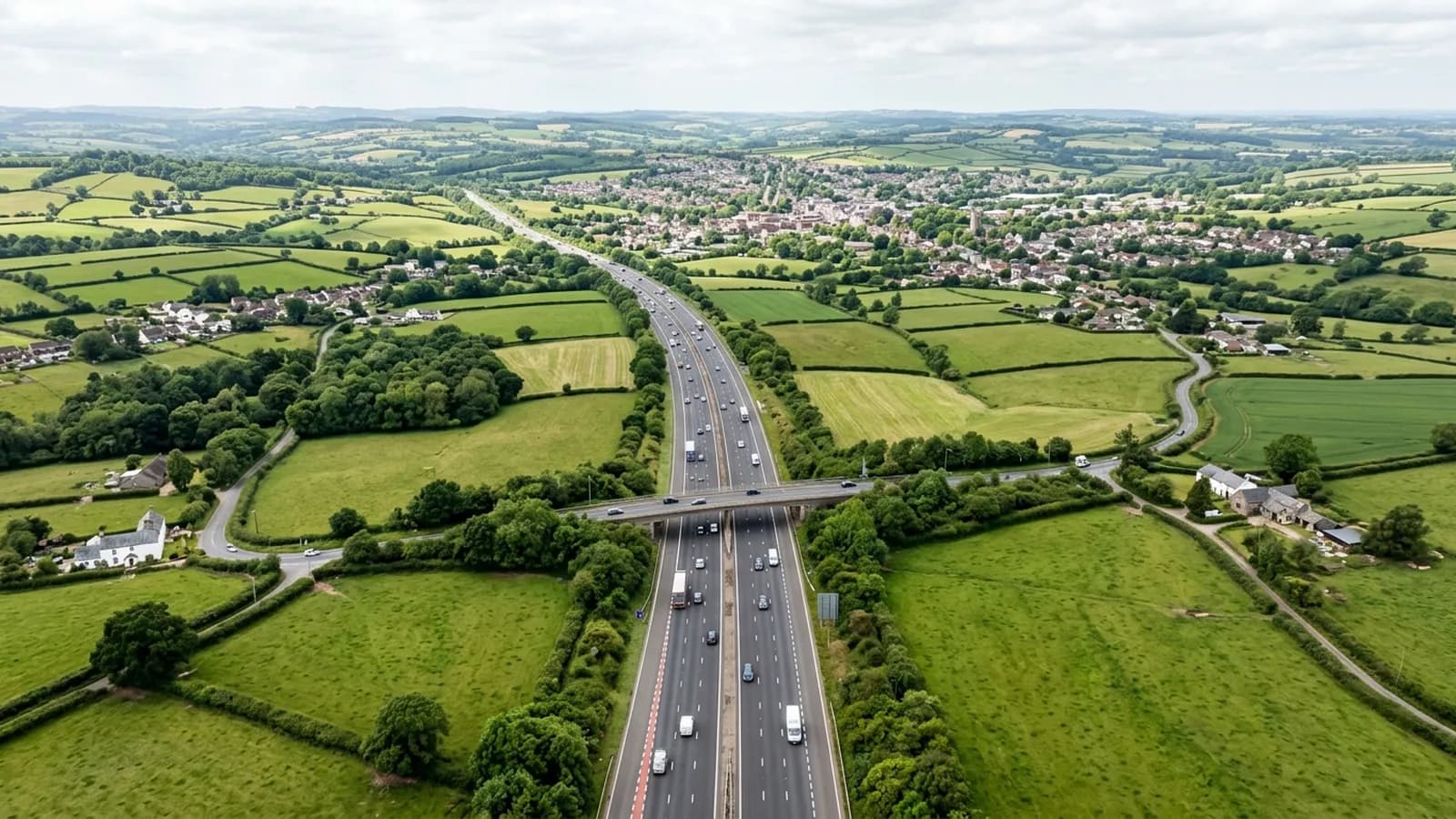 The M5 running north through Devon and Somerset farmland with a market town spread out in the middle distance